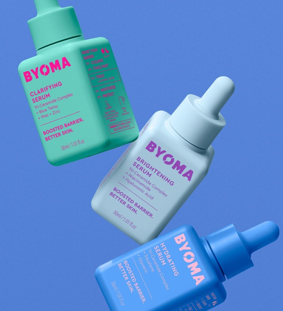 BYOMA serums in green, white, and blue bottles floating against a blue background.