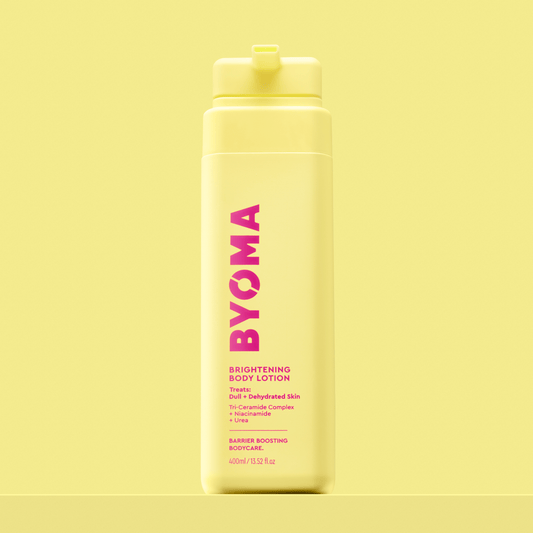 BYOMA Brightening Body Lotion in a yellow bottle.